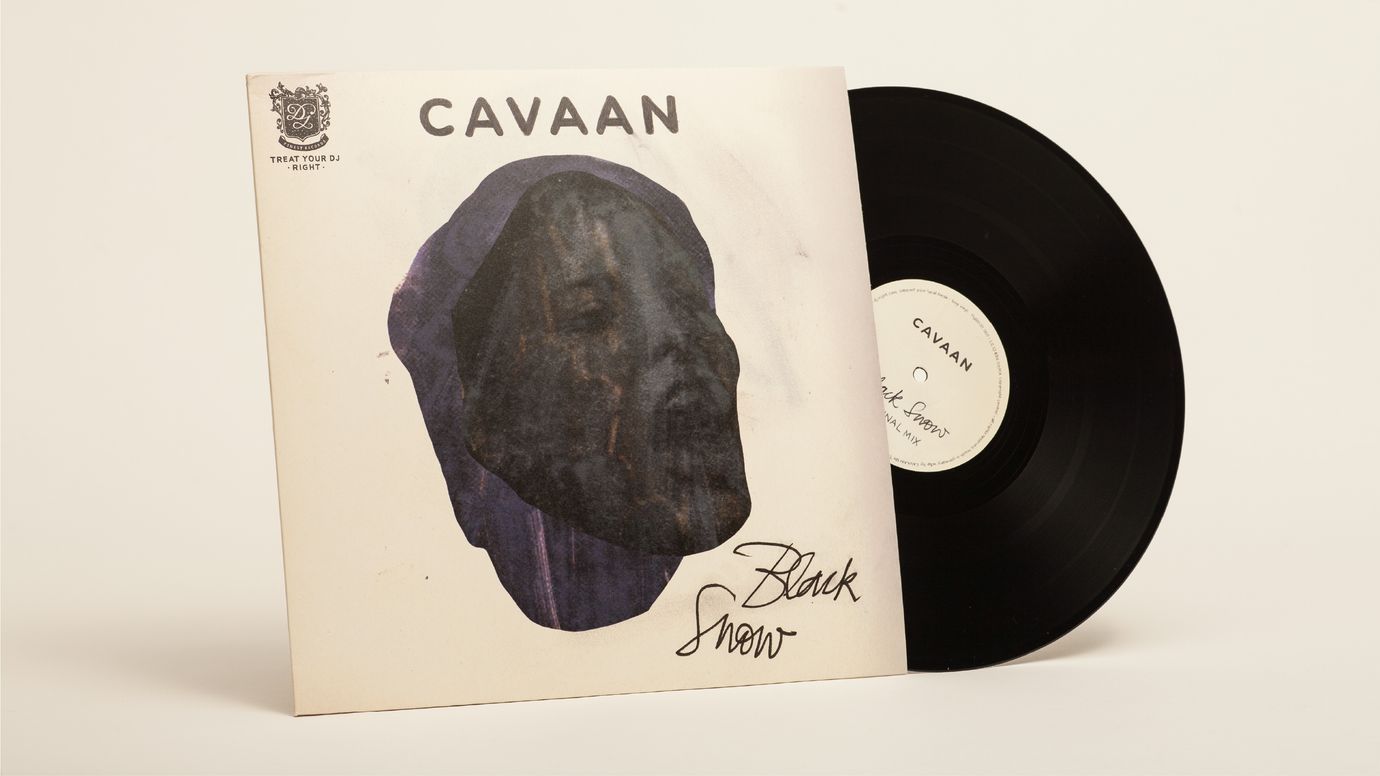 Album cover, the record has been partially removed. The cover features a collaged illustration of a screaming woman's head. The artist's name, Cavaan, is written at the top centre above the illustration. The handwritten title Black Snow is in the lower right corner.